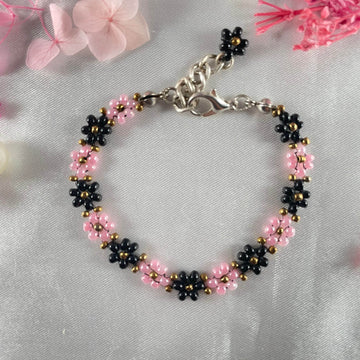 Daisy Flowers bracelet, made with rose Pink, and black Colour, Golden bead finishing